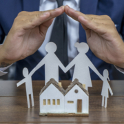 insurer-protecting-a-family-with-his-hands-multiple-exposure